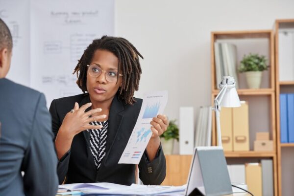 portrait-attractive-cuban-woman-presenting-statistical-information-her-unrecognizable-boss_1098-20618-600x401